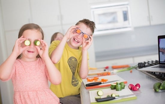 kids having fun with vegetables in cooking class
