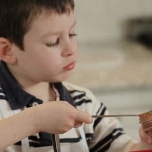 boy measuring food with spoon