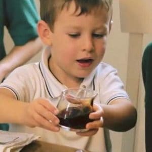 boy preparing to pour cup
