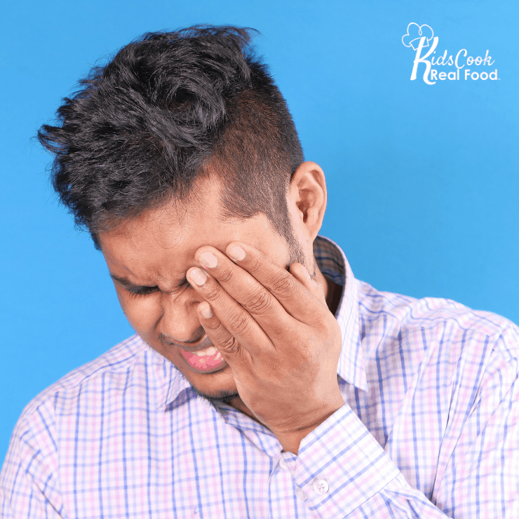 man rubbing head
