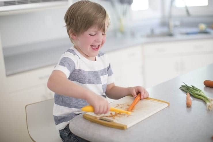 Kids learn to cook by peeling a carrot