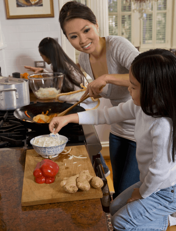 mom and two kids cooking together