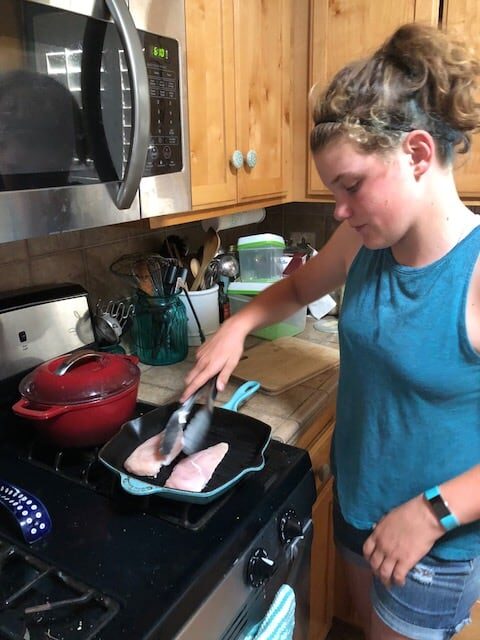 girl cooking chicken