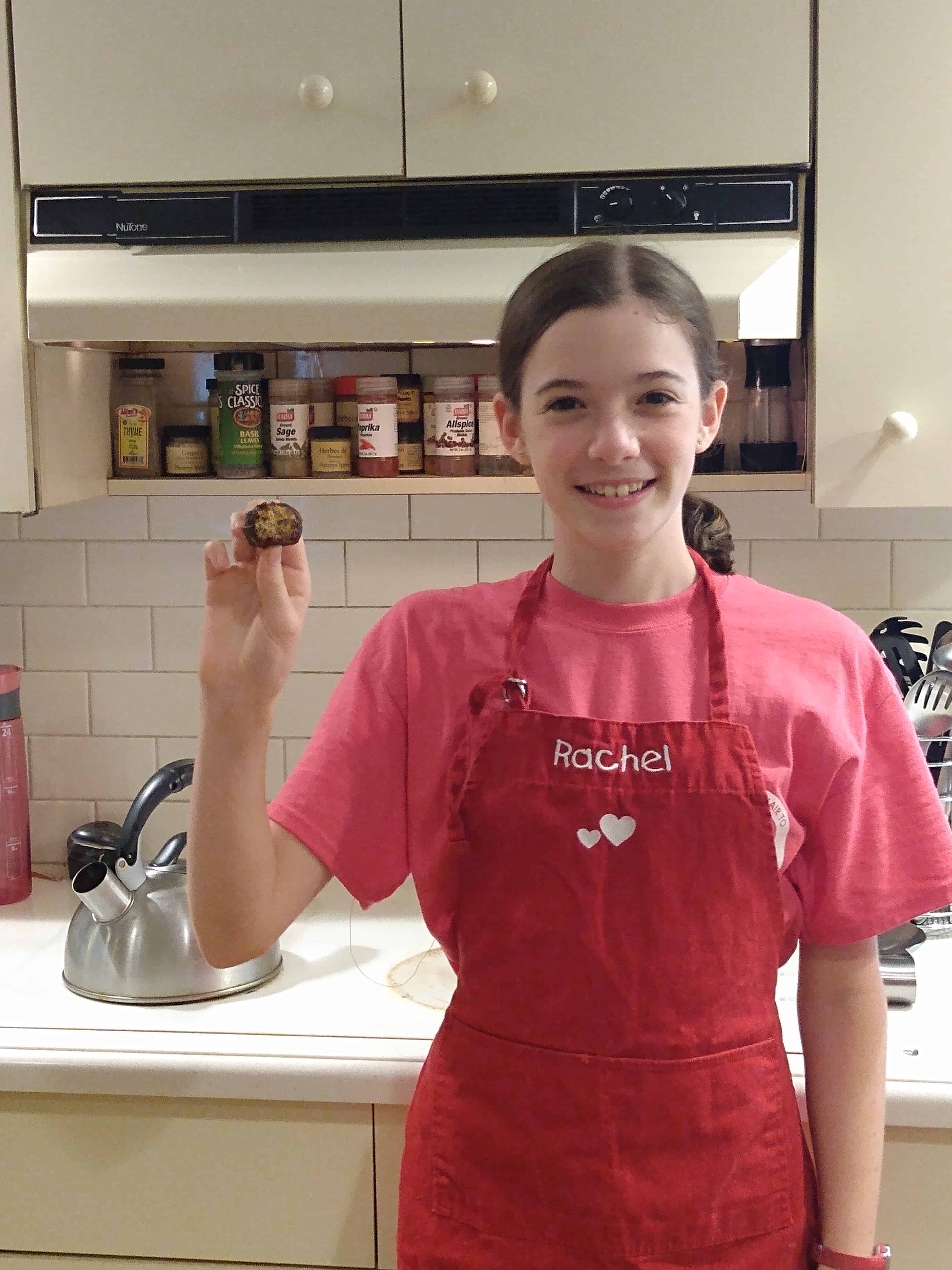 rachel in kitchen in an apron