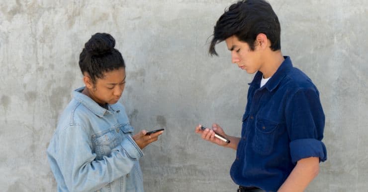 teens looking at phones