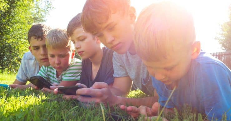 row of kids looking at screens