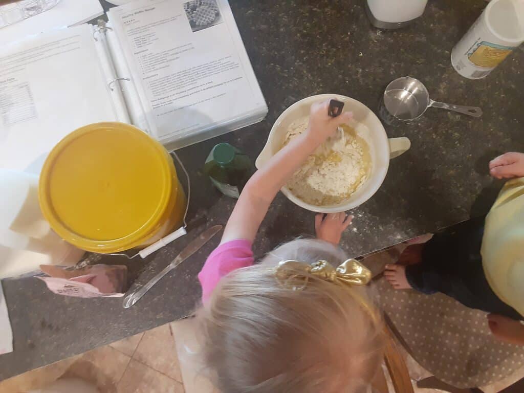little girl stirring in the kitchen