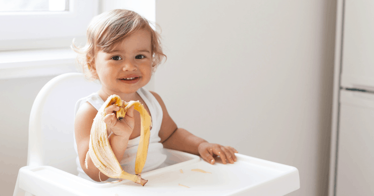 toddler eating banana