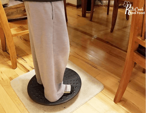 boy standing on a balance board