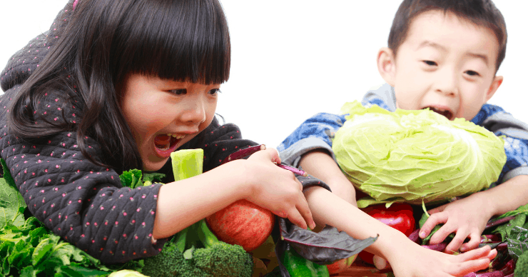 Kids shoving vegetables into their mouths