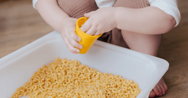 Child playing in a sensory bin