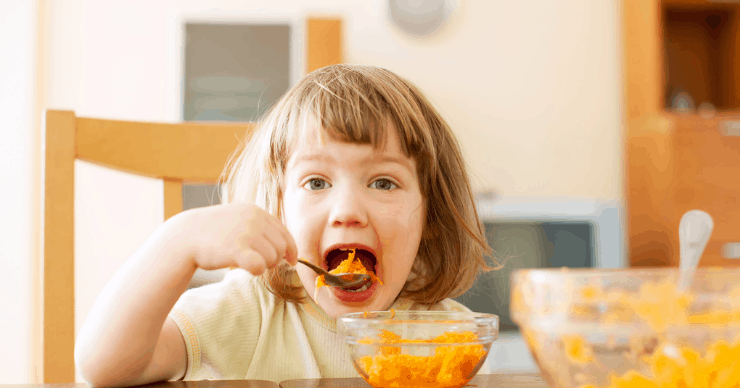 Child eating squash with a spoon