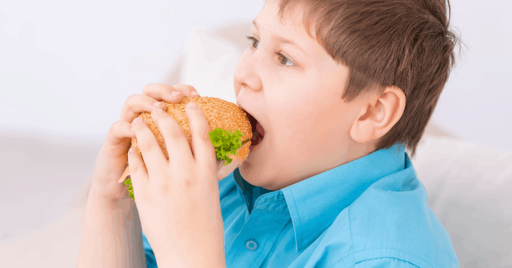 boy eating a cheeseburger