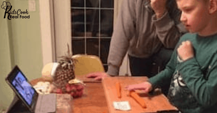 kid cutting carrot