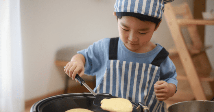 boy cooking pancakes