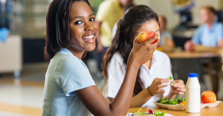 teen eating an apple