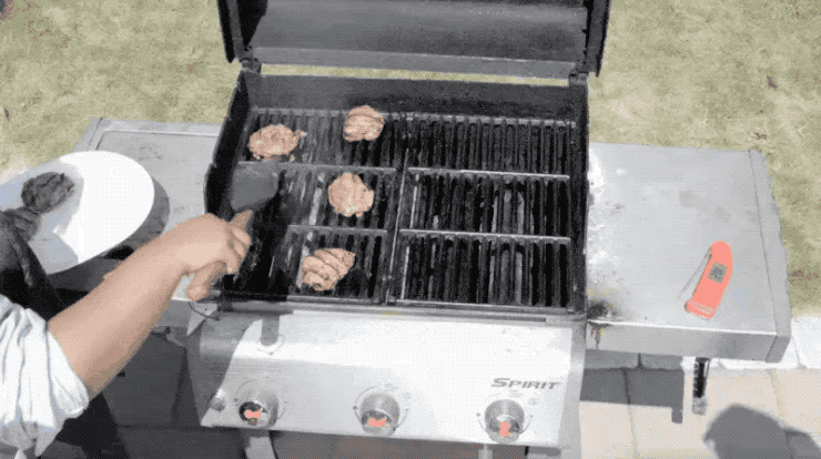 Taking burgers off a grill