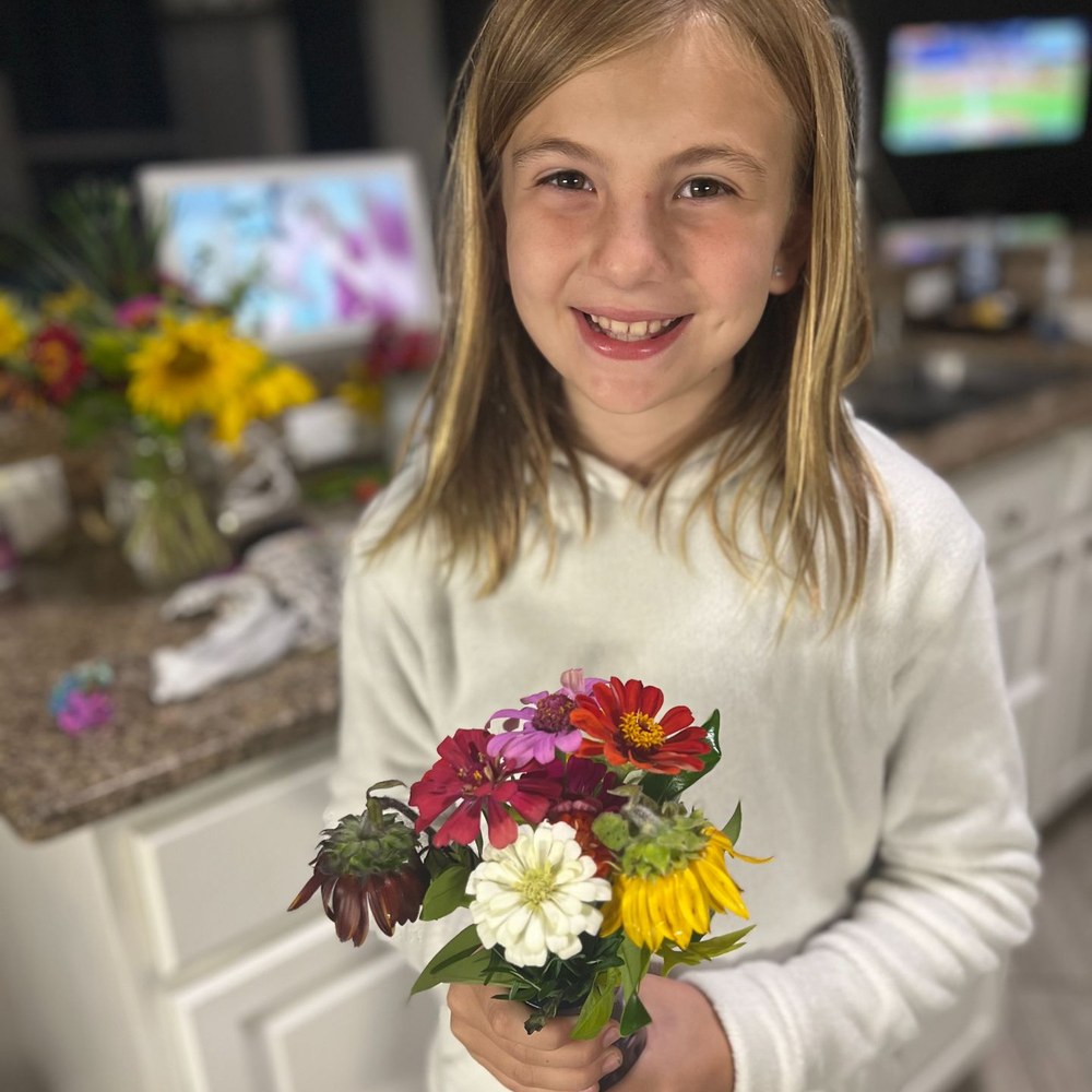 Girl holding the flower bouquet she arranged