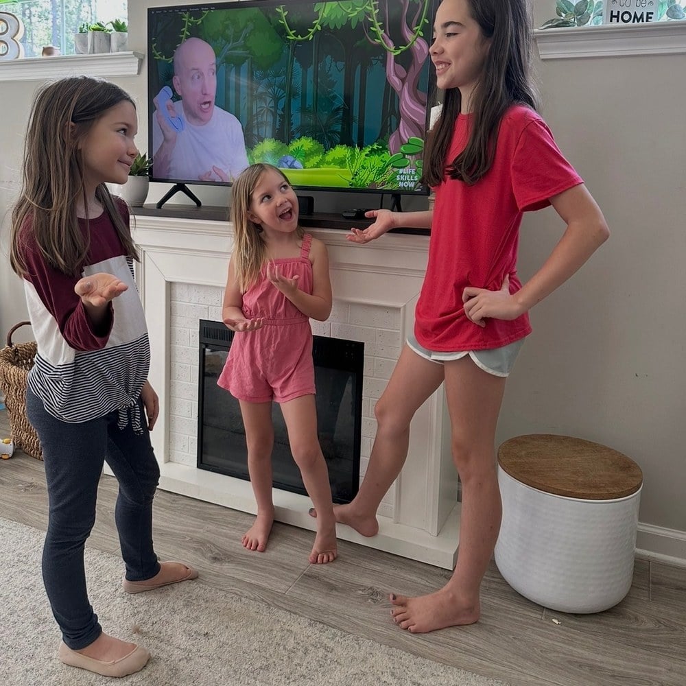 Three girls practising how to introduce themselves to each other